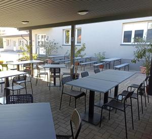 a group of tables and chairs in a patio at Abturist penzion in Štúrovo