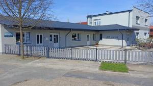 a house with a fence in front of it at Abturist penzion in Štúrovo