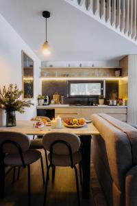 a kitchen with a table and chairs in a kitchen at Monside Resort - EARTH CABIN in Borzont