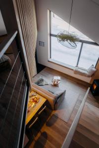 a small room with a table and a large window at Monside Resort - EARTH CABIN in Borzont