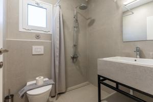 a bathroom with a shower and a toilet and a sink at Stay in Falassarna Rooms & Apartments in Falasarna