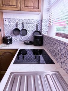 a kitchen with a sink and a counter top at Andover Bungalow in Penton Mewsey