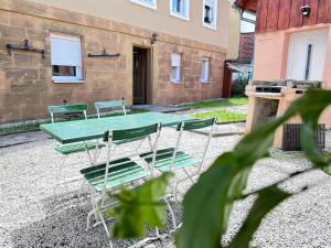a picnic table and chairs in a courtyard at Suite House - Magnolia - Oak - Sage in Bayreuth