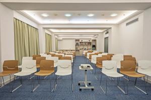 a room with rows of chairs and a podium in it at Airotel Stratos Vassilikos Hotel in Athens
