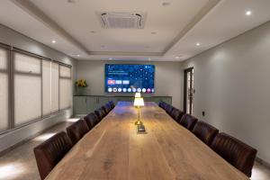a conference room with a long table and leather chairs at Merino Inn Hotel in Colesberg +13 photos