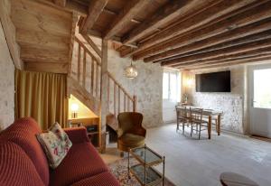 a living room with a couch and a table at Small country house with authentic charm in Baurech