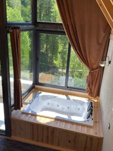 a bath tub in a room with a window at Ponte Butik Otel in Çamlıhemşin +95 photos