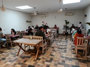 a group of people sitting at tables in a restaurant at Sultan Hostel & Guesthouse in Istanbul