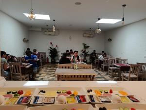 a group of people sitting at tables in a restaurant at Sultan Hostel & Guesthouse in Istanbul