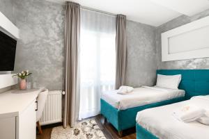 a hotel room with two beds and a window at One Luxury Suites AKUSTIK - 3 minuta peške do Jezera in Zlatibor
