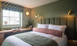a bedroom with a large bed and a desk at Sigma Plus Regency Square Suites near Brighton Beach in Brighton & Hove