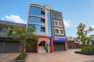 a tall building with a red door in front at FabHotel Prakash & Sons, Hoshangabad Rd in Somarda Kauasot