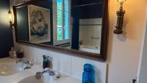 a bathroom with a sink and a mirror at Au moulin d'Izaourt in Izaourt +81 photos