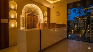 a lobby with a counter in front of a door at Hotel The Hidden Door-Near Jaipur Airport in Jaipur