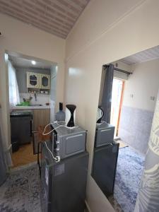a kitchen with a microwave and a refrigerator at Rosemond cottages eldoret in Eldoret