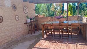 a patio with a wooden table and chairs on a patio at Casa Estrella in Villafamés