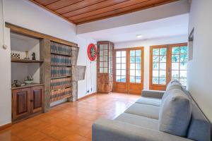 a living room with a couch and a book shelf at Sao Mateus Ocean View in São Mateus