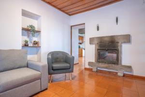 a living room with a couch and a fireplace at Sao Mateus Ocean View in São Mateus