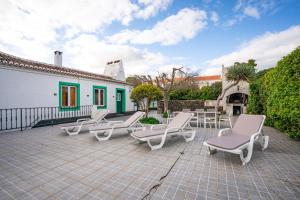 a group of chairs and tables on a patio at Sao Mateus Ocean View in São Mateus