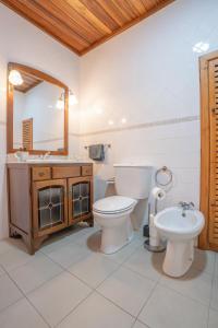 a bathroom with a toilet and a sink and a mirror at Sao Mateus Ocean View in São Mateus +52 photos