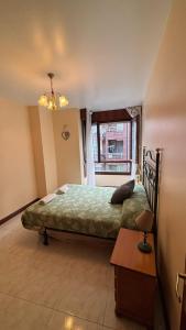 a bedroom with a bed and a window at piso en la playa in Noja