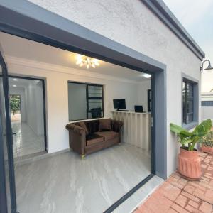 a living room with a sliding glass door at Cozy Villa Lodge in Edenvale