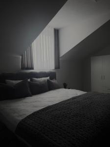 a bedroom with a large bed and a large window at AD PRESTIGE Apartment in Gradačac