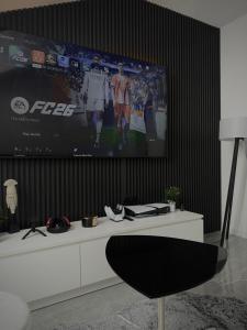 a living room with a large tv on a wall at AD PRESTIGE Apartment in Gradačac
