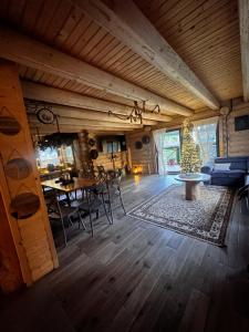 a living room with a table and a christmas tree at Chałupy w Lesie Skawinki in Skawinki
