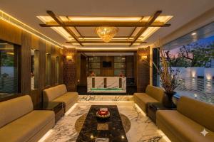 a living room with couches and a table at Hotel Golden Manor-City Center Bani Park in Jaipur