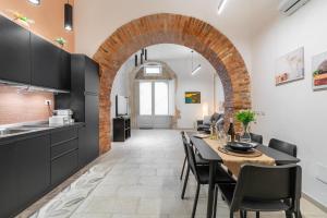 a kitchen and dining room with a table and chairs at Atena Ortigia in Syracuse