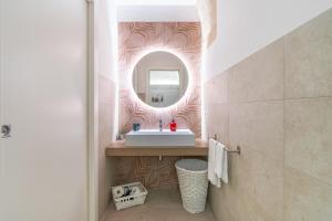 a bathroom with a sink and a mirror at Atena Ortigia in Syracuse +19 photos