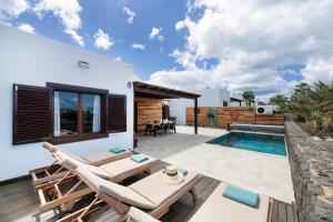 a villa with a swimming pool and a patio at Casa Andrada in Yaiza