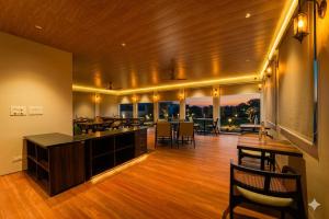 a living room with a table and a dining room at R41 - Boutique Hotel Vaishali Nagar Jaipur in Jaipur