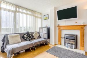 a living room with a couch and a fireplace at 1 Bed in West Bay oc-wy537 in West Bay