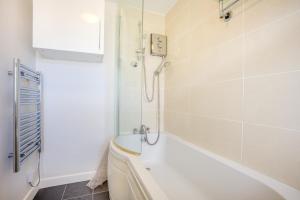 a white bathroom with a tub and a shower at 1 Bed in West Bay oc-wy537 in West Bay +17 photos