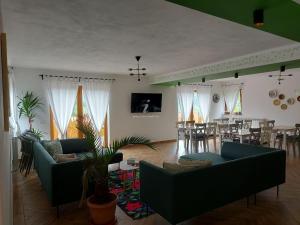 a living room with two couches and a dining room at Casa Măriucăi - Ciubar&Mountain View in Borşa
