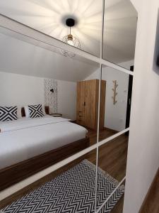 a bedroom with a bed and a glass wall at Casa Măriucăi - Ciubar&Mountain View in Borşa
