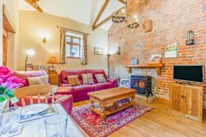a living room with a couch and a brick wall at 1 Bed in Market Rasen oc-73852 in East Barkwith