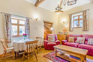 a living room with a red couch and a table at 1 Bed in Market Rasen oc-73852 in East Barkwith