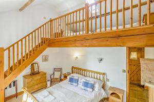a bedroom with a bed and a wooden staircase at 1 Bed in Market Rasen oc-73852 in East Barkwith