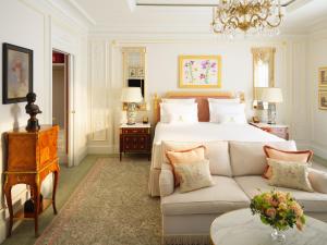 a large bedroom with a bed and a couch at The Ritz London in London