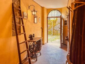a hallway with a room with a ladder and a table at Casa al Sasso - Appartamenti immersi nella natura in Lizzano in Belvedere