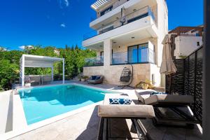a swimming pool in the backyard of a house at Villa Aquilla in Tivat