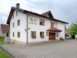 a white building with a sign on the side of it at Haus Baden in Hagnau