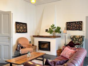 a living room with a couch and a fireplace at Guest apartment in the castle in Höör