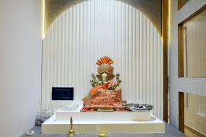 a statue sitting on a table in a room at HOTEL GOLD LEAF in Ahmedabad