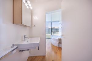 a bathroom with a sink and a bath tub at Pedrinhas Village by Geyra in Esposende +34 photos