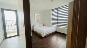 a small bedroom with a bed and a window at BenHill - serviced apartment-Binh Duong in Ấp Dừa +19 photos