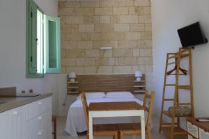 a room with a bed and a desk and a ladder at Agriturismo Le Tagliate in Uggiano la Chiesa
